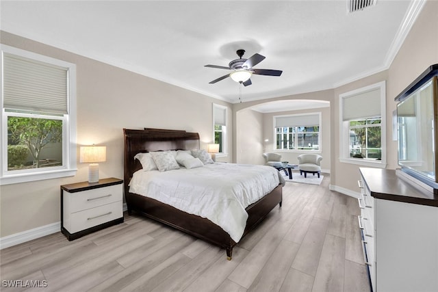 bedroom featuring ceiling fan, light hardwood / wood-style flooring, and ornamental molding