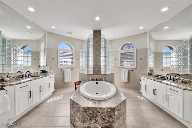 bathroom with plus walk in shower, tile patterned flooring, vanity, and vaulted ceiling