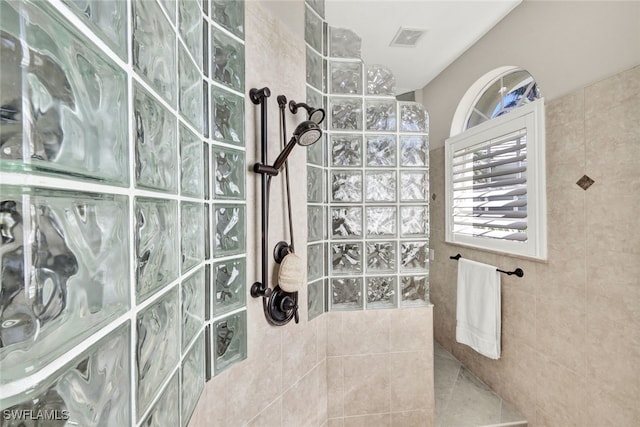 bathroom with tiled shower