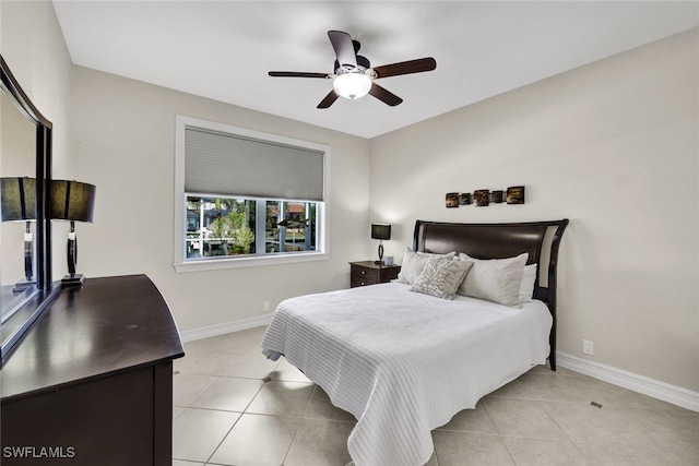 bedroom with ceiling fan and light tile patterned floors