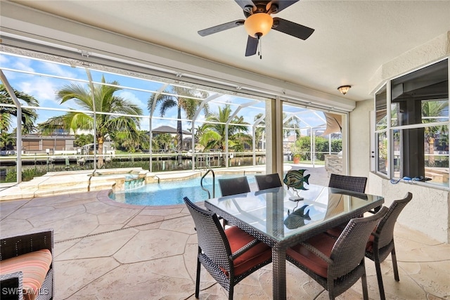 sunroom / solarium featuring ceiling fan, a water view, and a pool