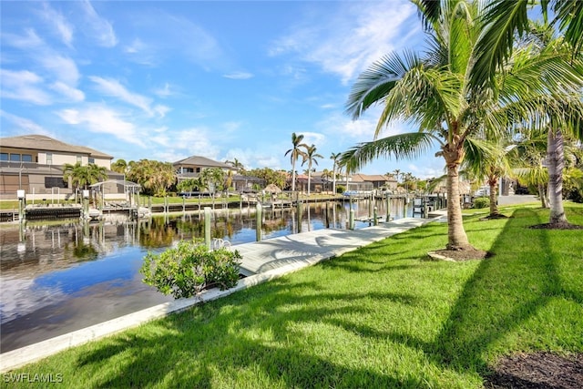 dock area featuring a lawn and a water view