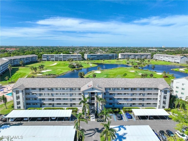 aerial view featuring view of golf course and a water view