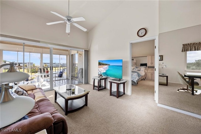 living room with high vaulted ceiling, carpet, a healthy amount of sunlight, and a ceiling fan