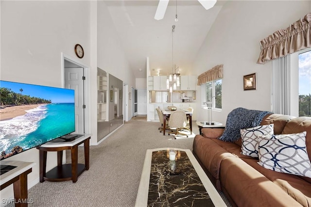 living area featuring ceiling fan, high vaulted ceiling, and light colored carpet