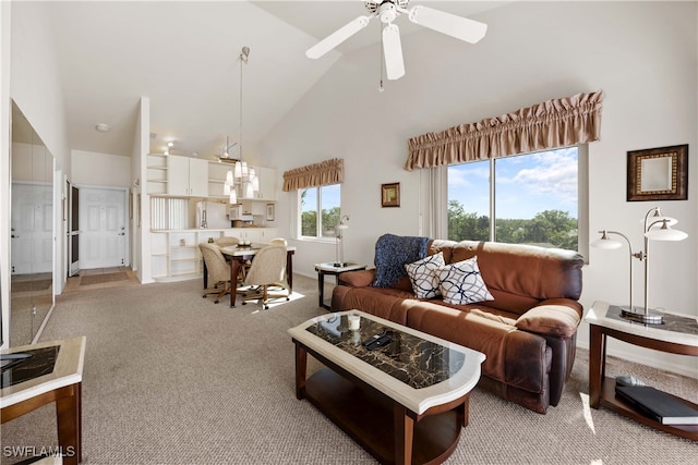 carpeted living room featuring ceiling fan and high vaulted ceiling