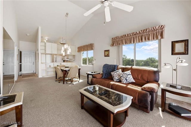 living room featuring high vaulted ceiling, light colored carpet, and a ceiling fan