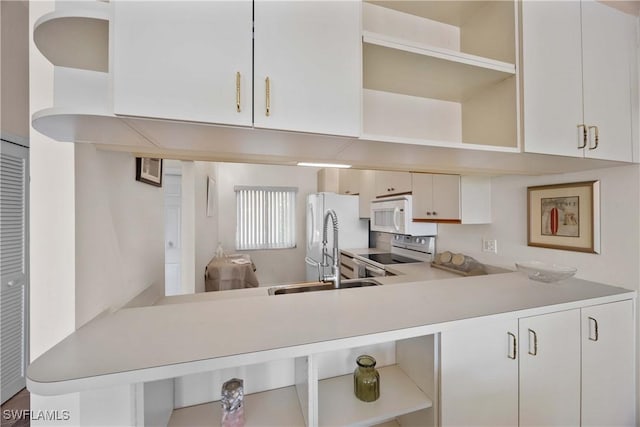 kitchen with open shelves, white appliances, light countertops, and white cabinets