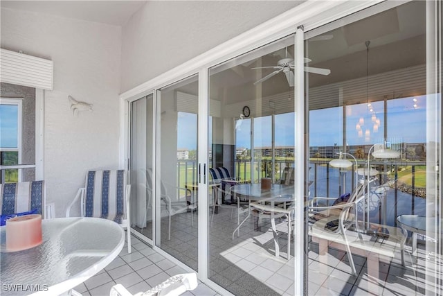 balcony with a sunroom and a ceiling fan