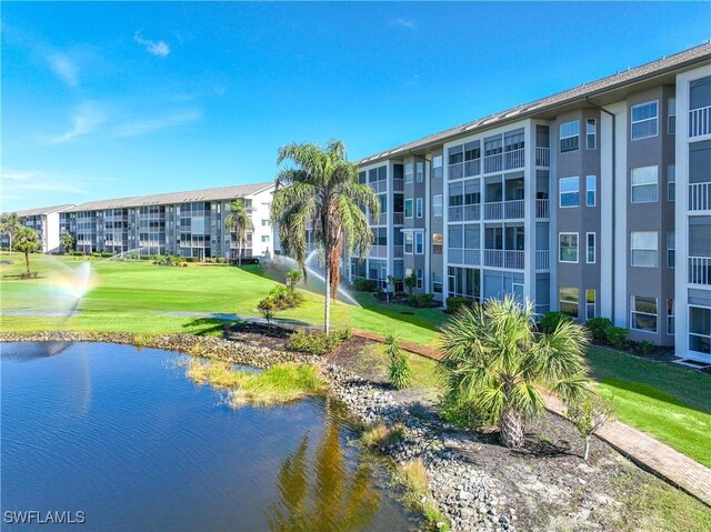 14871 Hole In 1 Cir Unit Ph1, Fort Myers, FL 33919 - surrounding community with a yard and a water view