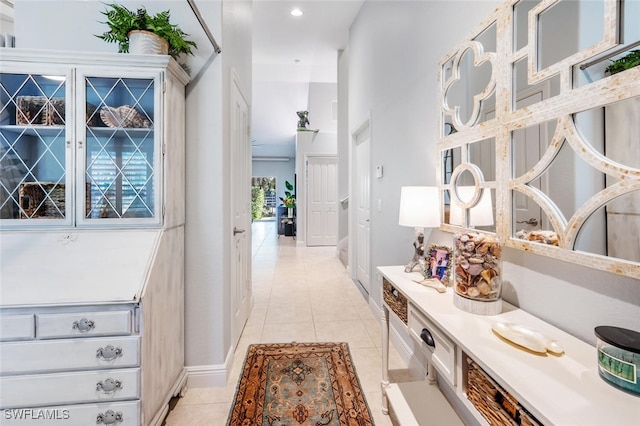 hall featuring light tile patterned floors