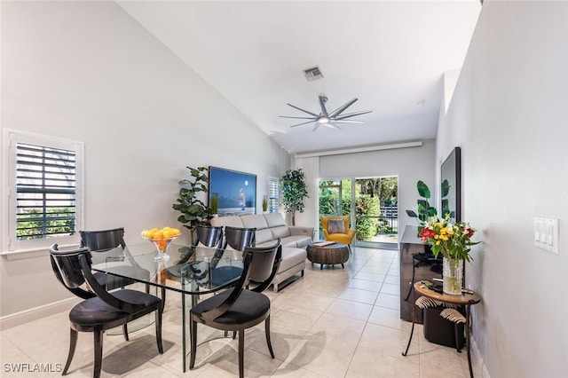 tiled living room with high vaulted ceiling, ceiling fan, and a healthy amount of sunlight