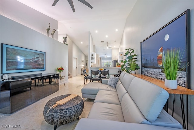 living room with light tile patterned floors, high vaulted ceiling, and ceiling fan