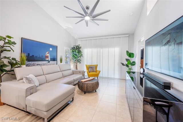 living room with ceiling fan, high vaulted ceiling, and light tile patterned floors