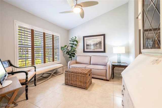 sitting room featuring ceiling fan, light tile patterned floors, and vaulted ceiling