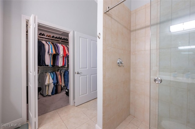 bathroom with tile patterned floors and walk in shower