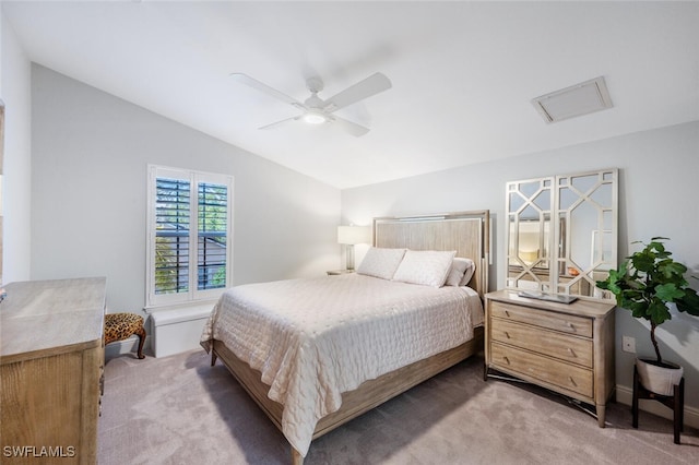 carpeted bedroom with ceiling fan and lofted ceiling