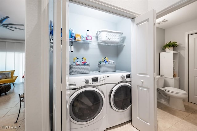 laundry room with light tile patterned floors and washer and clothes dryer