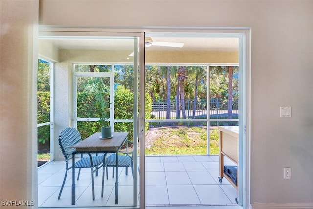 doorway to outside featuring light tile patterned flooring