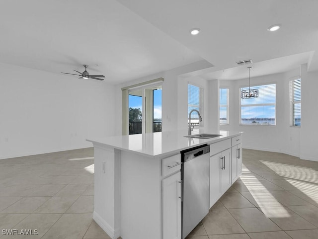 kitchen with a kitchen island with sink, white cabinets, sink, stainless steel dishwasher, and plenty of natural light