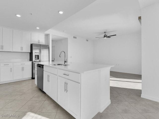 kitchen with a kitchen island with sink, white cabinets, sink, ceiling fan, and appliances with stainless steel finishes