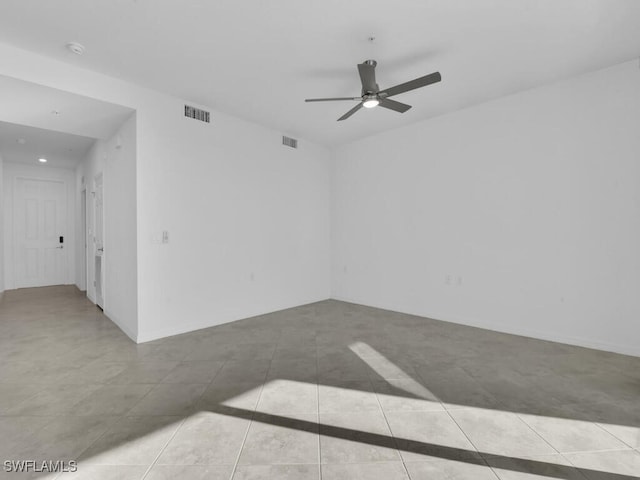 empty room featuring ceiling fan and light tile patterned floors