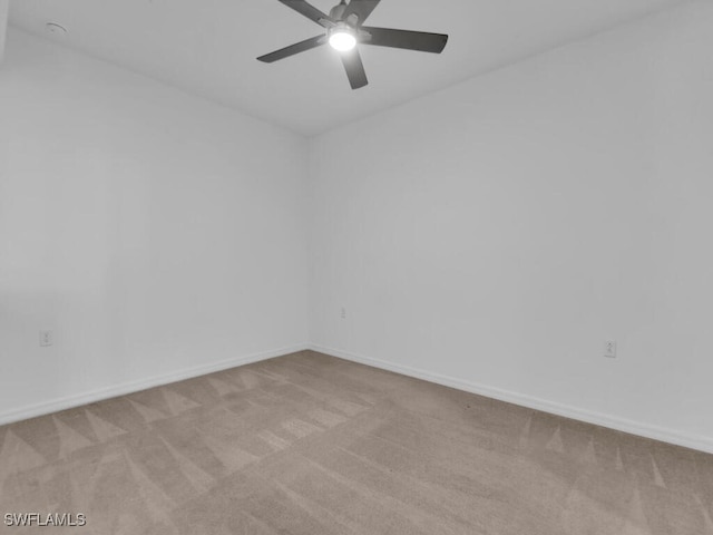 empty room featuring light carpet and ceiling fan