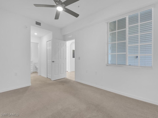 unfurnished room with ceiling fan and light colored carpet