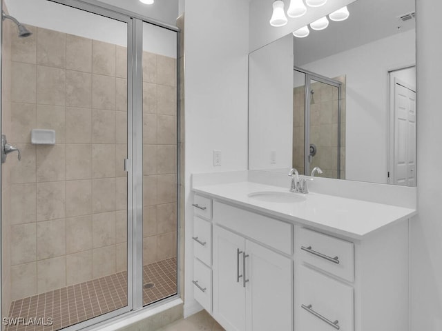 bathroom featuring vanity and an enclosed shower