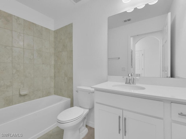 full bathroom with tile patterned floors, vanity, toilet, and tiled shower / bath combo