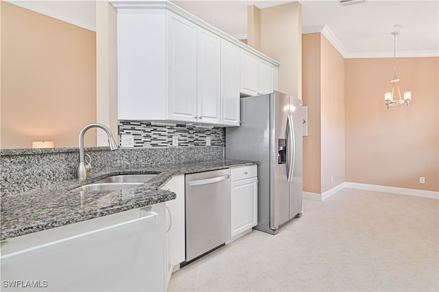 kitchen featuring sink, dark stone countertops, tasteful backsplash, white cabinetry, and stainless steel appliances