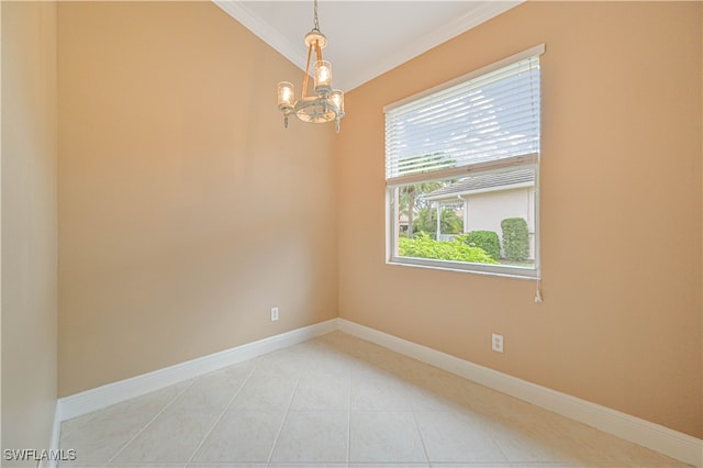 empty room featuring ornamental molding, light tile patterned floors, and an inviting chandelier