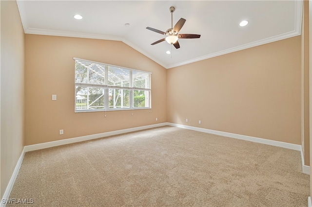 carpeted empty room featuring ceiling fan, lofted ceiling, and ornamental molding