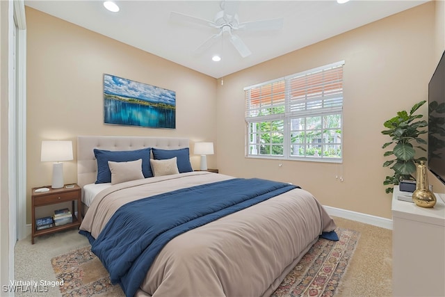 bedroom with ceiling fan and light carpet