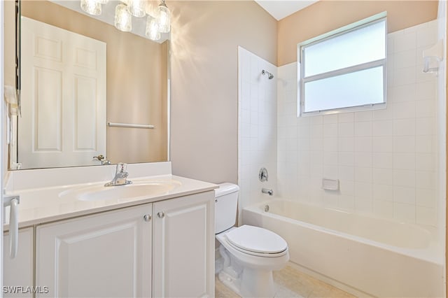 full bathroom with tile patterned floors, vanity, tiled shower / bath combo, and toilet