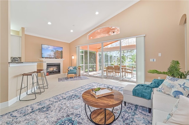 living room with tile patterned floors, crown molding, and high vaulted ceiling