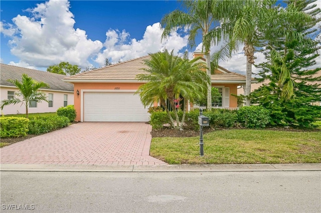 view of front of home with a garage and a front lawn