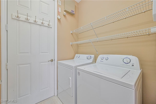 clothes washing area with washer and dryer