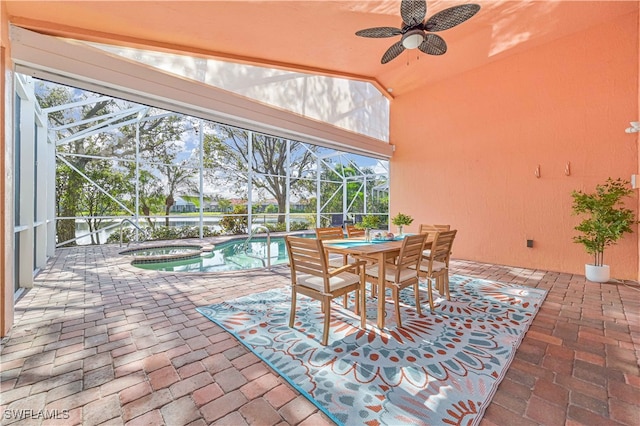 view of patio featuring ceiling fan, a swimming pool with hot tub, and a lanai