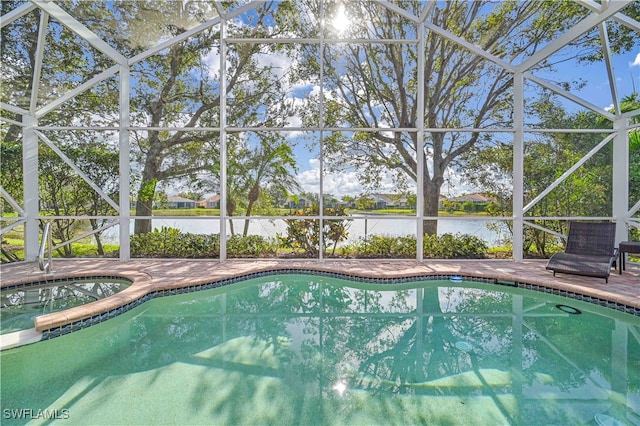 view of pool with a patio area, an in ground hot tub, a water view, and glass enclosure