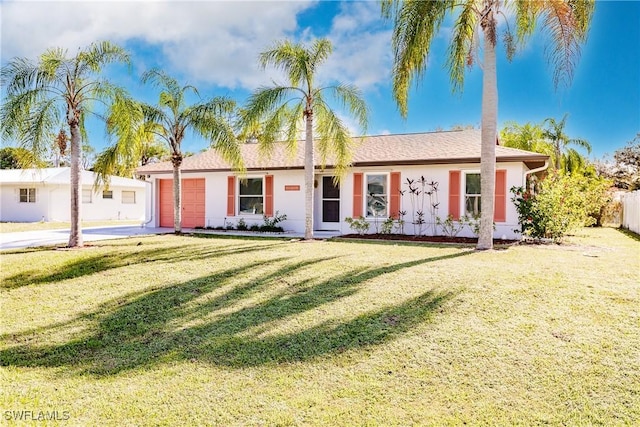 ranch-style home with a front yard and a garage