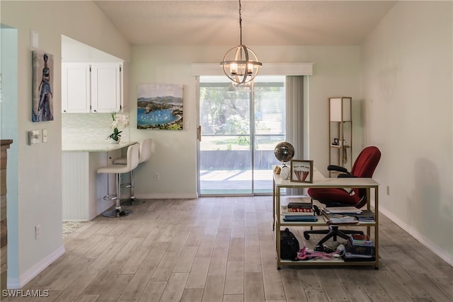 dining space featuring light hardwood / wood-style flooring, vaulted ceiling, and a notable chandelier