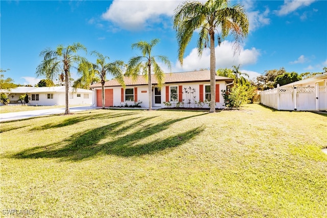 ranch-style house with a garage and a front lawn