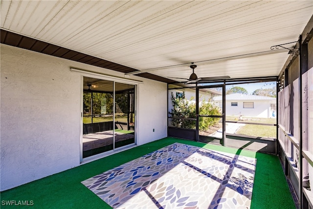 unfurnished sunroom featuring ceiling fan