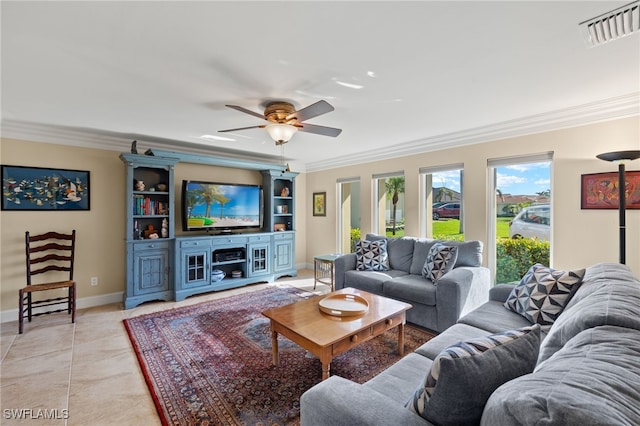 tiled living room with ceiling fan and crown molding