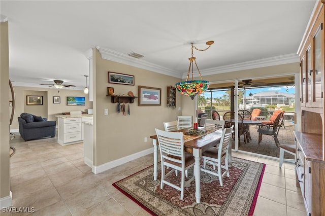 dining area with crown molding, light tile patterned floors, and ceiling fan