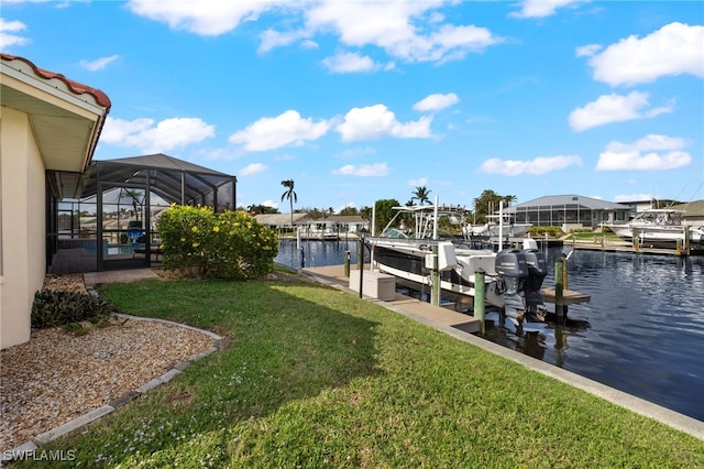 view of dock with a yard, a water view, and a lanai