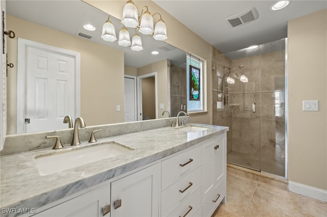 bathroom with tile patterned flooring, vanity, walk in shower, and an inviting chandelier