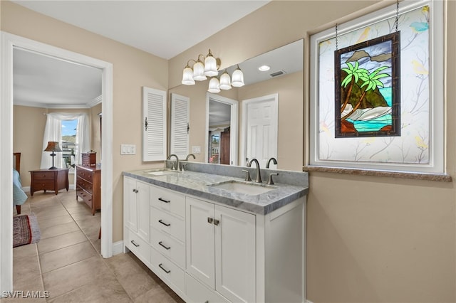 bathroom featuring tile patterned flooring, vanity, and crown molding