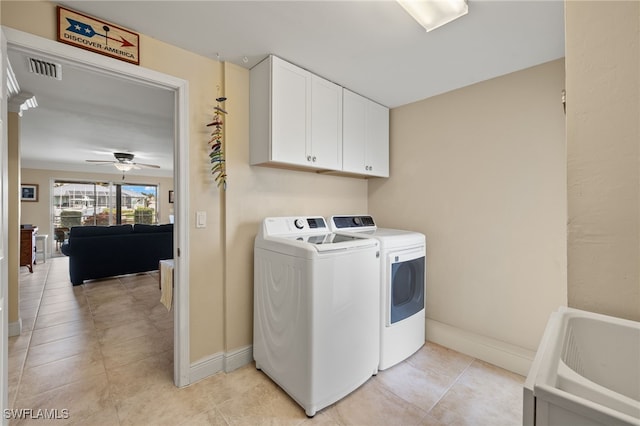 laundry room featuring washer and dryer, ceiling fan, cabinets, and light tile patterned flooring